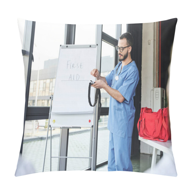 Personality  Paramedic In Eyeglasses And Blue Uniform Standing At Flip Chart With First Aid Lettering And Showing Compressive Tourniquet To Students On Blurred Foreground, Life-saving Skills Concept Pillow Covers