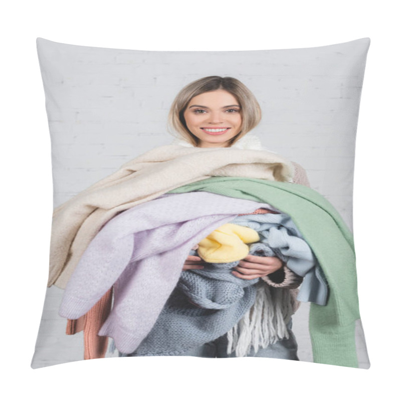 Personality  Smiling Woman Holding Knitted Sweaters And Looking At Camera On White Background Pillow Covers