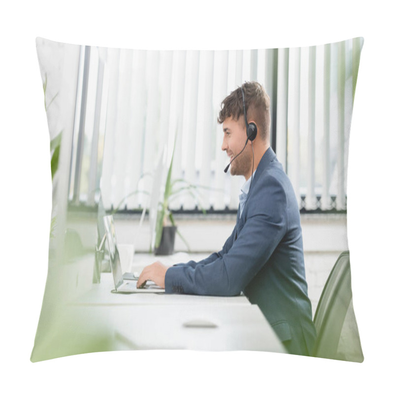 Personality  Smiling Man In Headset Typing On Laptop, While Sitting At Workplace With Plants In Office On Blurred Foreground Pillow Covers