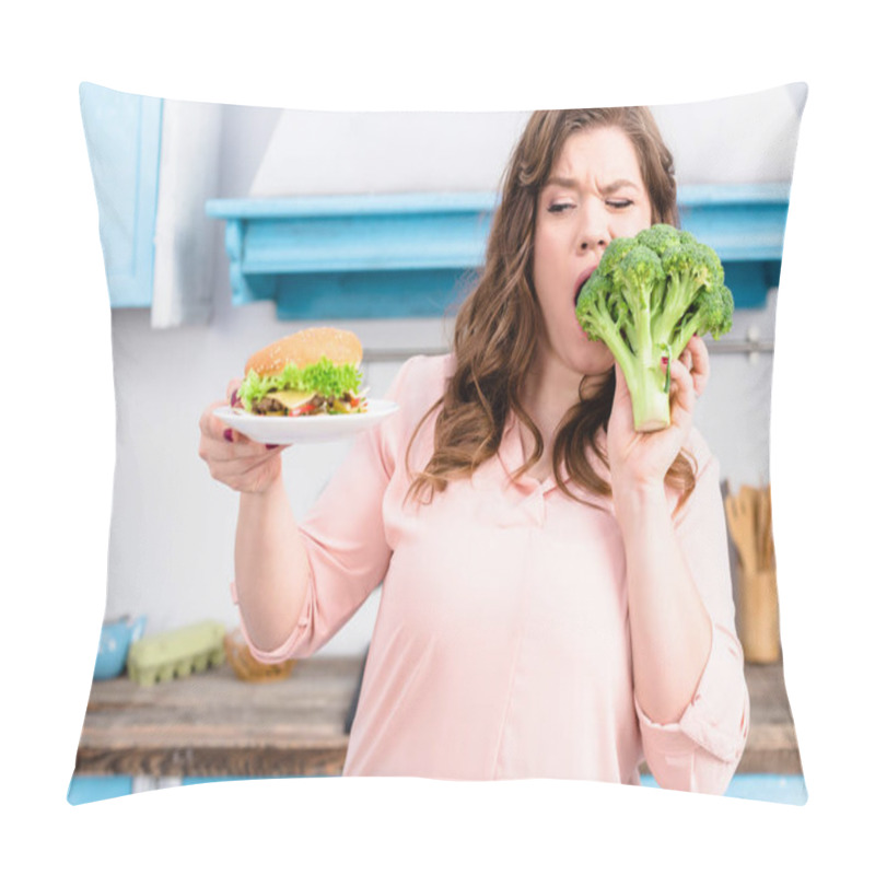 Personality  Portrait Of Overweight Woman With Burger Biting Fresh Broccoli In Hands In Kitchen At Home, Healthy Eating Concept Pillow Covers