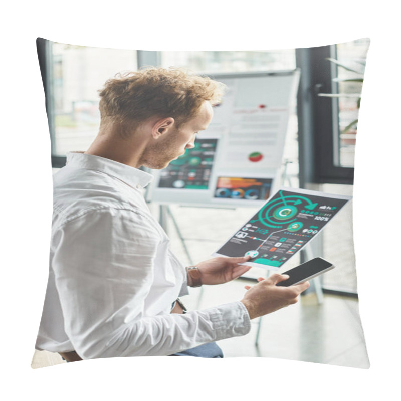 Personality  A Committed Redhead Businessman Studies Project Metrics While Seated In A Stylish, Contemporary Office Setting. Pillow Covers