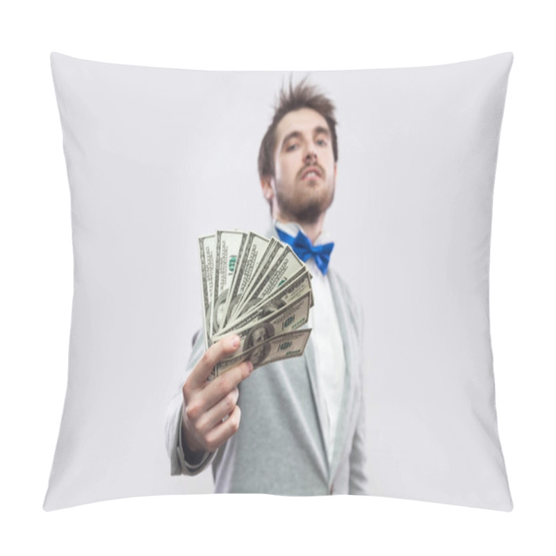 Personality  Confident Young Businessman In Gray Coat And Blue Bow Tie Standing Proudly With Head Up And Giving Dollars On Gray Background. Pillow Covers