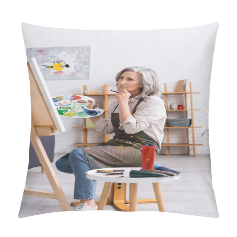 Personality  Pensive Mature Artist Holding Paintbrush And Palette While Sitting Near Canvas  Pillow Covers