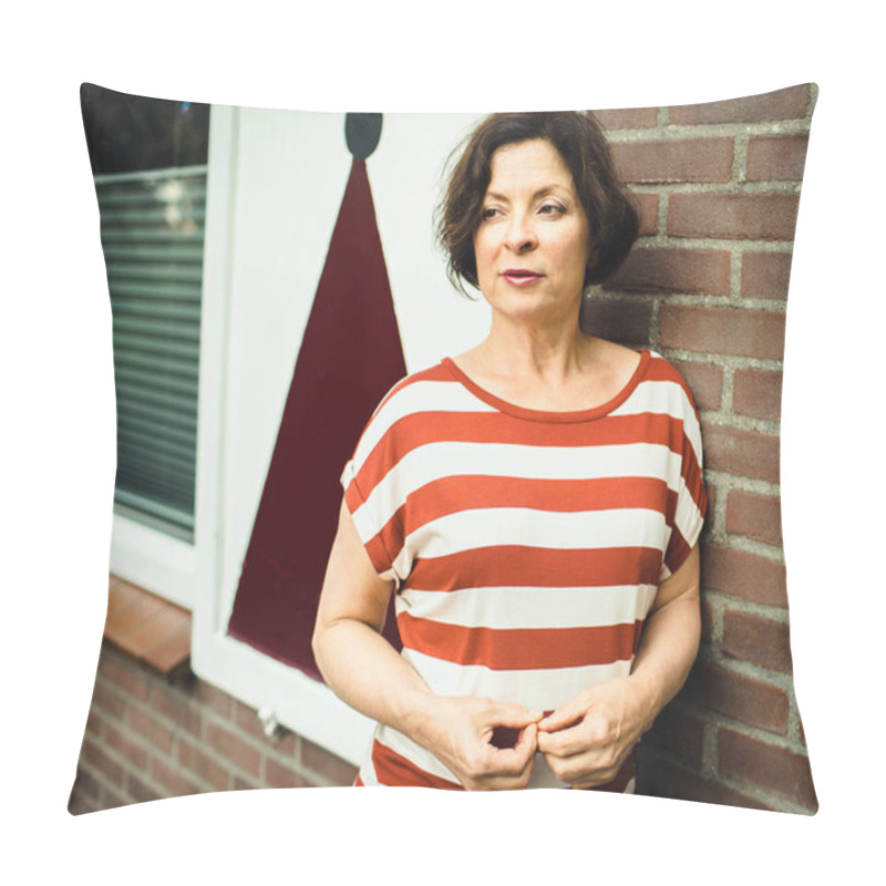 Personality  Pensive Mature Woman In A Striped Shirt Of Orange And White Stands On The Street On A Background Of A Brick Wall And A Typical Dutch Window. Pillow Covers