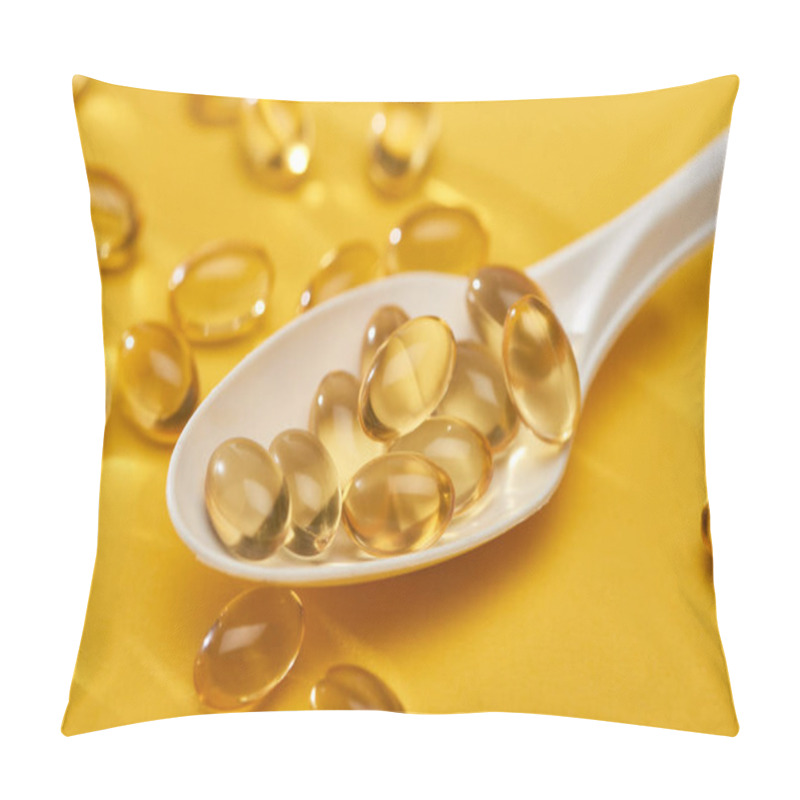 Personality  Close Up View Of Golden Shiny Fish Oil Capsules Scattered From Spoon On Yellow Bright Background Pillow Covers