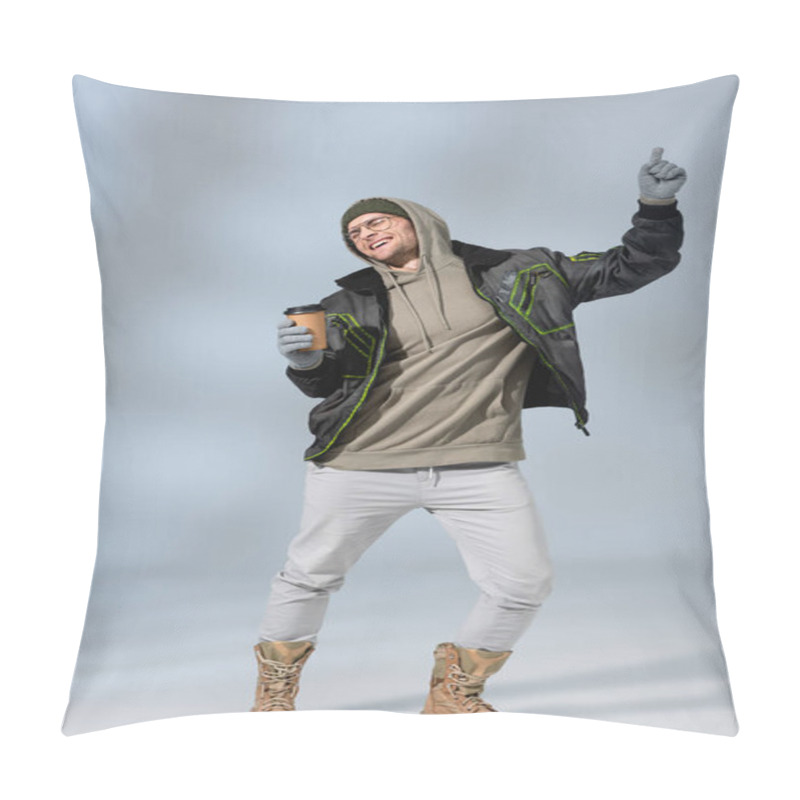 Personality  Full Length Of Young Happy Man In Hat, Hoodie And Anorak Holding Paper Cup And Dancing On Grey Pillow Covers