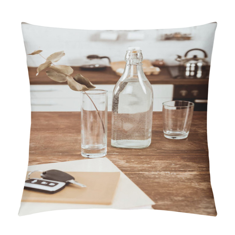 Personality  Close Up View Of Remote Car Key, Bottle Of Water And Branch In Vase At Wooden Table In Kitchen  Pillow Covers