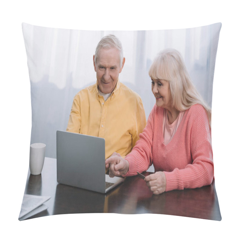 Personality  Smiling Senior Couple In Casual Clothes Using Laptop While Sitting At Table At Home Pillow Covers