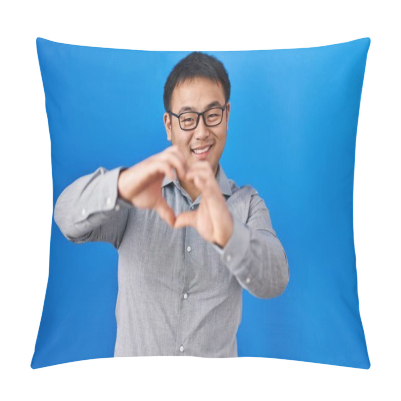 Personality  Young Chinese Man Standing Over Blue Background Smiling In Love Doing Heart Symbol Shape With Hands. Romantic Concept.  Pillow Covers