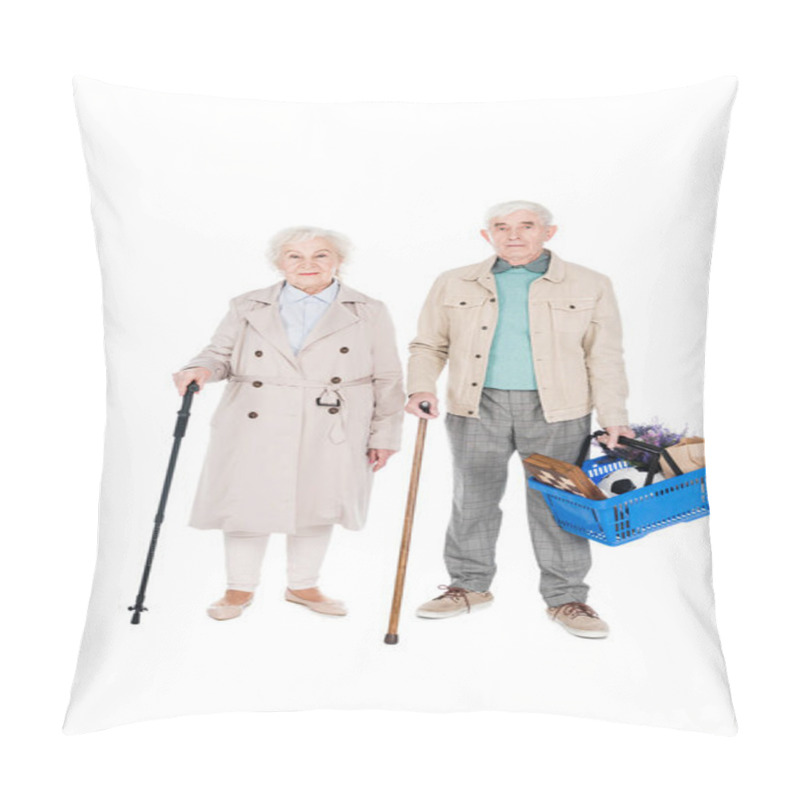 Personality  Cheerful Retired Couple Holding Shopping Baskets And Walking Canes While Standing Isolated On White Pillow Covers