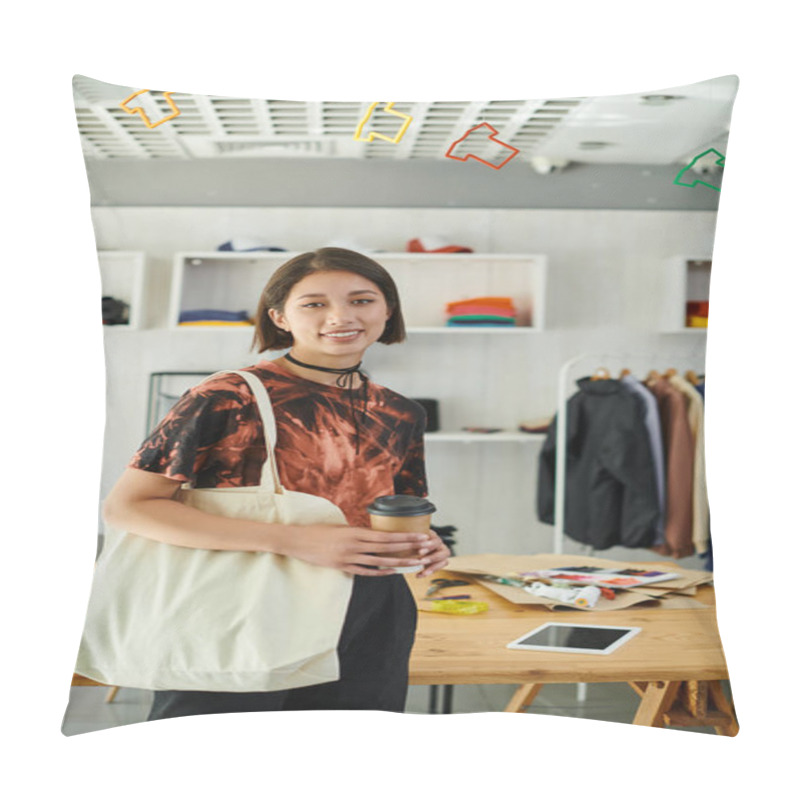 Personality  Happy Asian Designer With Canvas Shopping Bag And Coffee To Go Looking At Camera In Print Studio Pillow Covers