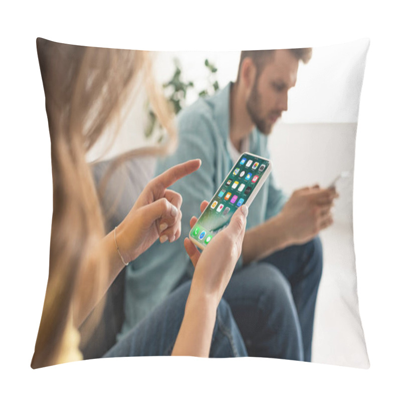 Personality  KYIV, UKRAINE - FEBRUARY 21, 2020: Selective Focus Of Woman Holding Smartphone With Iphone Screen Near Boyfriend In Living Room Pillow Covers