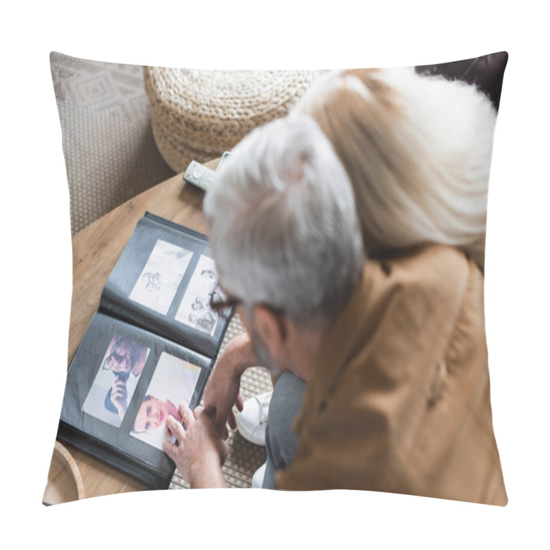 Personality  Overhead View Of Blurred Elderly Couple Sitting Near Photos In Album On Table  Pillow Covers