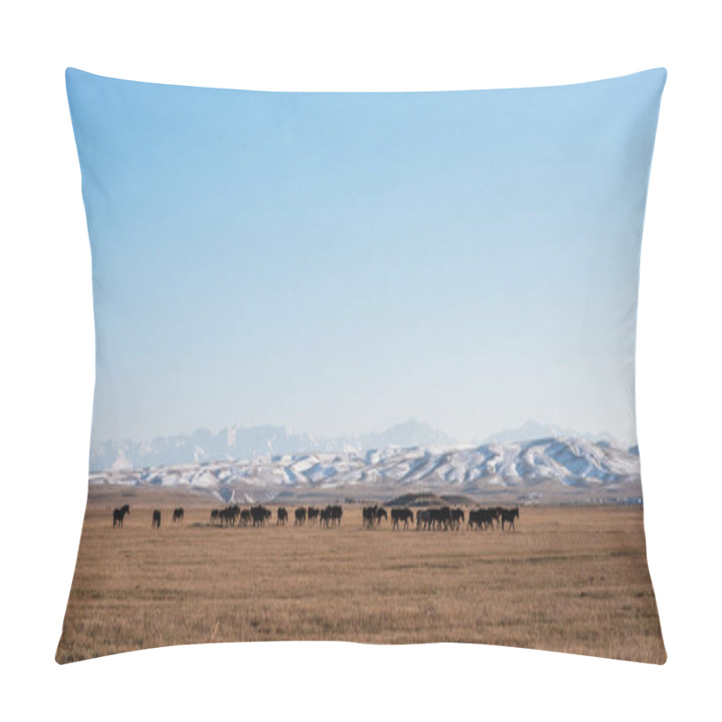 Personality  A Herd Of Dark Silhouetted Horses Grazes On A Vast, Golden Prairie, With A Delicate Dusting Of Snow On Distant Rolling Hills Under A Serene, Expansive Blue Sky. Pillow Covers