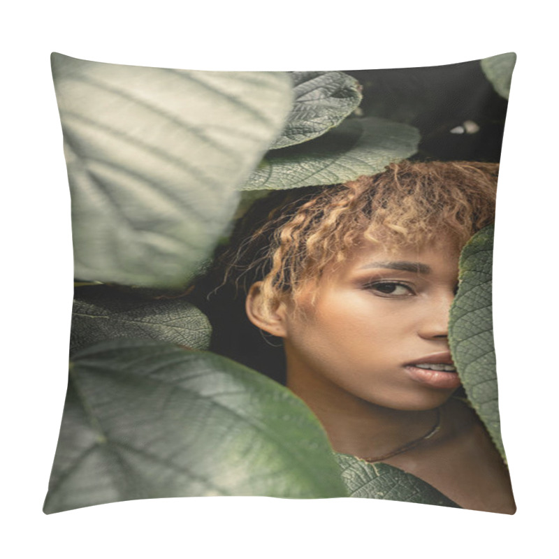 Personality  Portrait Of Young And Trendy African American Woman With Makeup Looking At Camera While Standing Behind Green Foliage In Greenhouse, Fashion-forward Lady In Tropical Oasis Pillow Covers