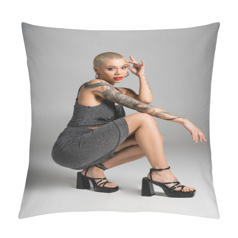 Personality  Full Length Of Fashionable Tattooed Woman On Heels Sitting On Haunches And Looking At Camera On Grey Background Pillow Covers