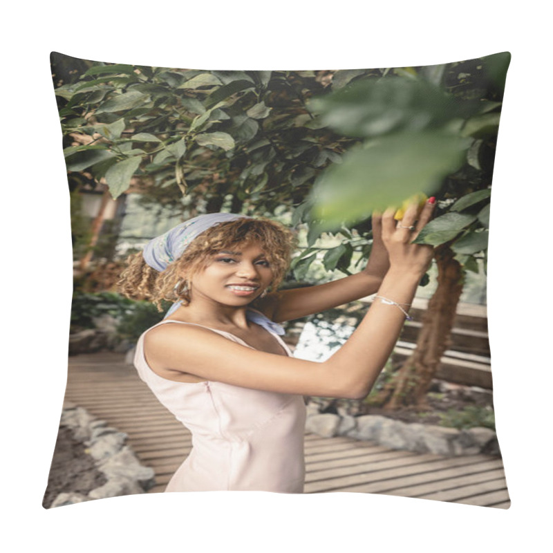 Personality  Smiling African American Woman With Braces Wearing Summer Outfit And Looking At Camera While Taking Fresh Lemon From Tree In Blurred Orangery, Stylish Woman With Tropical Plants At Backdrop Pillow Covers