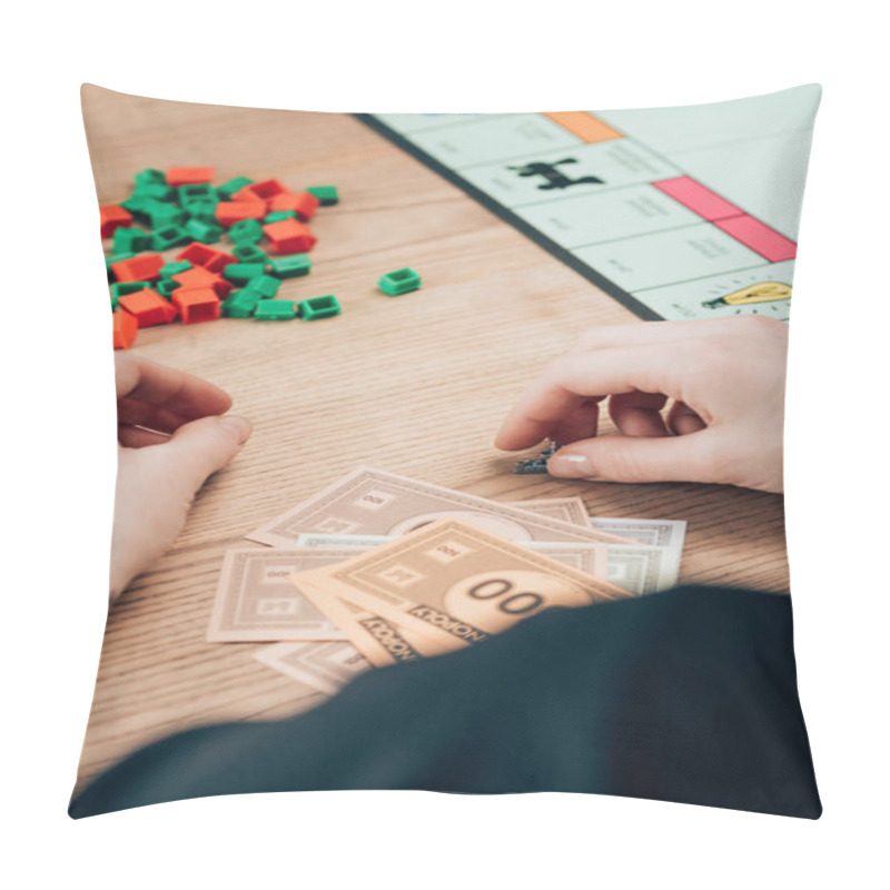 Personality  KYIV, UKRAINE - NOVEMBER 15, 2019: Cropped View Of Woman Playing Monopoly Game At Wooden Table Pillow Covers