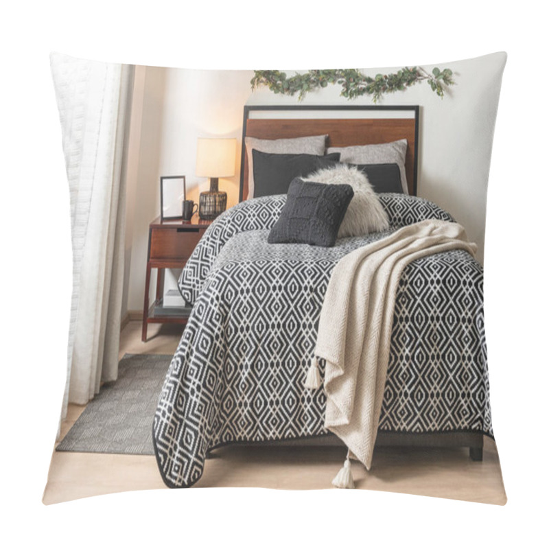 Personality  Interior Of A Modern Nordic Bedroom With A Comfortable Bed Featuring A Geometric Blanket, Black And Beige Pillows On The Bed, And A Wooden Bedside Table Pillow Covers