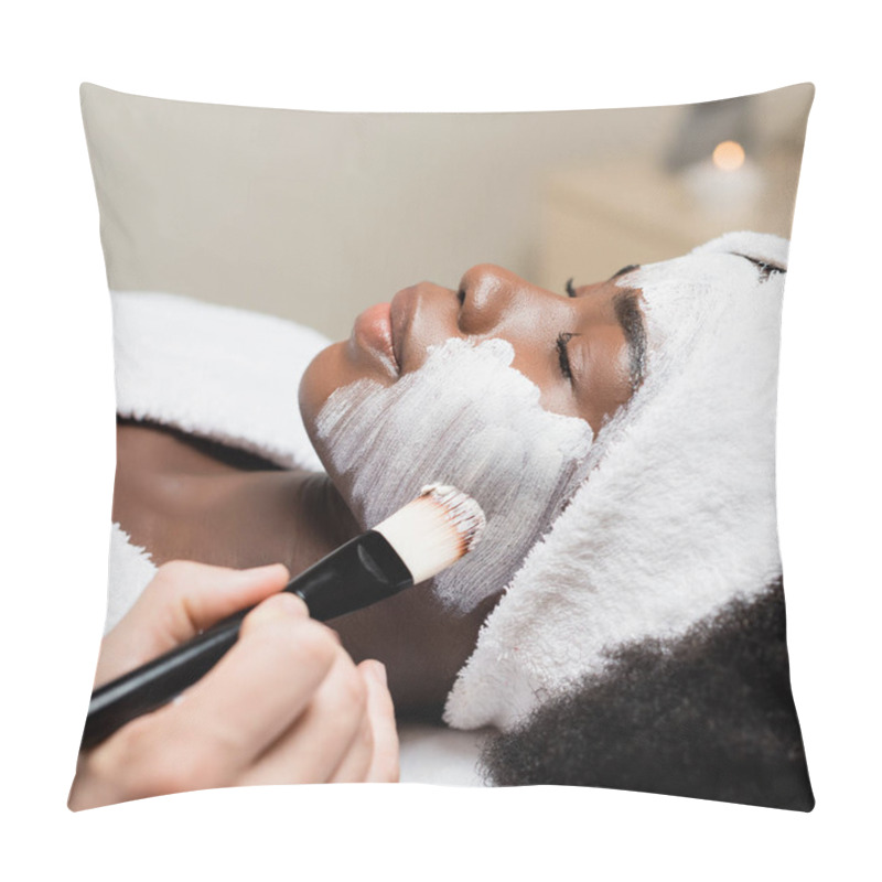 Personality  Close Up View Of Spa Therapist Applying Face Mask With Cosmetic Brush On Cheek Of African American Woman In Spa Salon On Blurred Background Pillow Covers