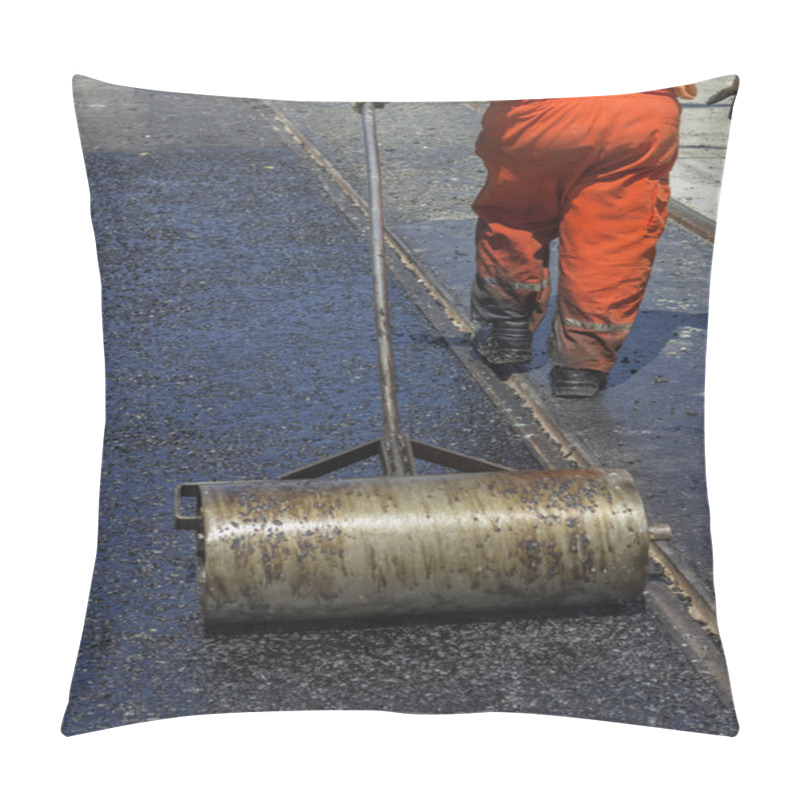 Personality  Worker using a hand roller for mastic asphalt paving pillow covers