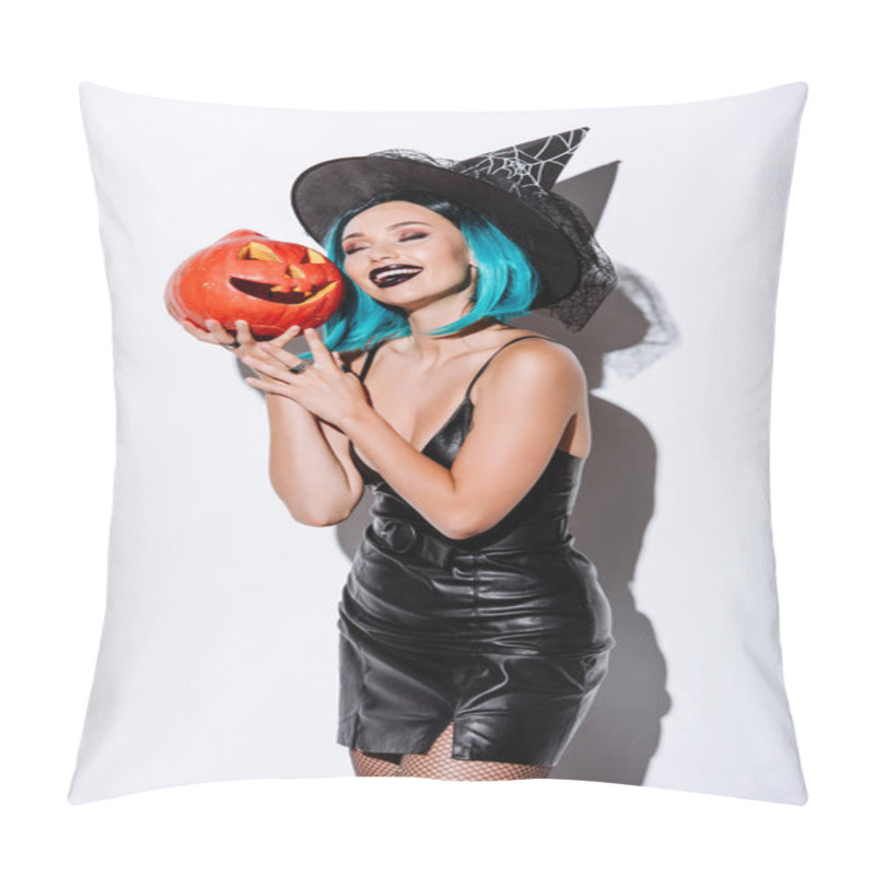 Personality  Pleased Sexy Girl In Black Witch Halloween Costume With Blue Hair Holding Spooky Carved Pumpkin On White Background Pillow Covers