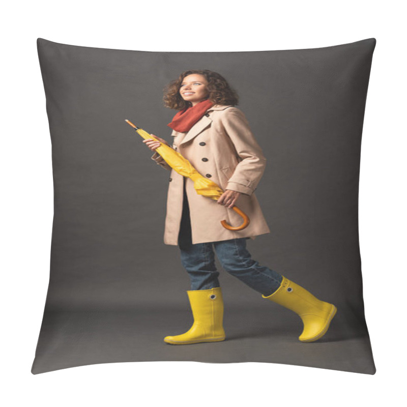 Personality  Cheerful Woman In Trench Coat And Rubber Boots Holding Yellow Umbrella On Black Background Pillow Covers