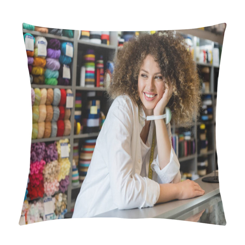 Personality  Happy Saleswoman With Needle Cushion On Hand Looking Away Near Counter And Rack With Needlework Accessories Pillow Covers