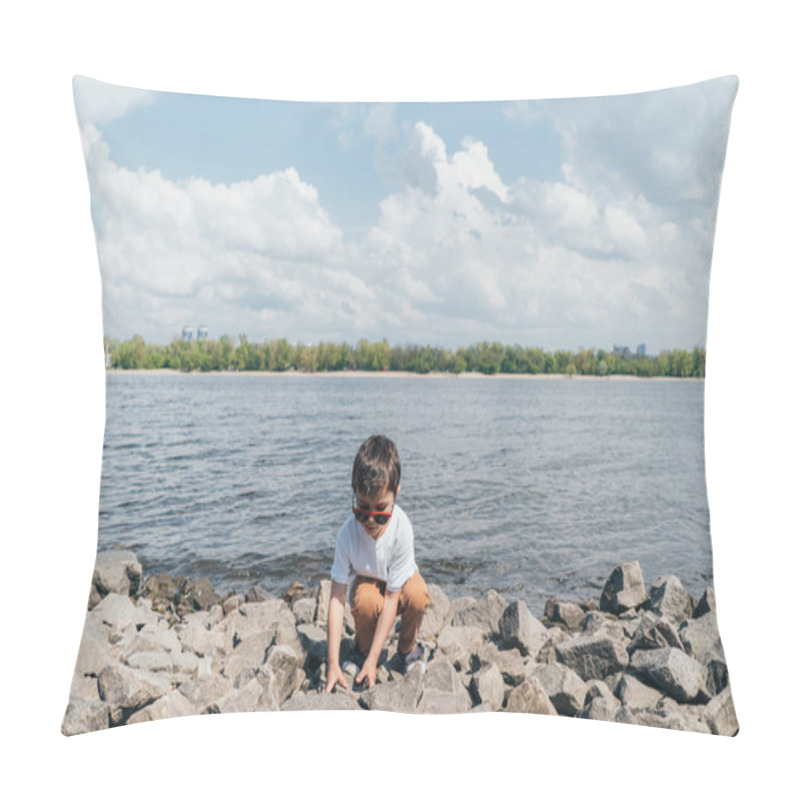 Personality  Stylish Boy In Sunglasses Touching Rock While Sitting Near Lake Pillow Covers