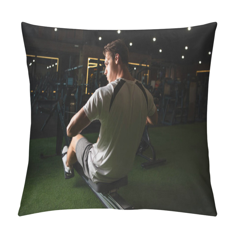 Personality  Back View Of Man Training On Pull Rope Exercising Machine In Sitting Pose Pillow Covers