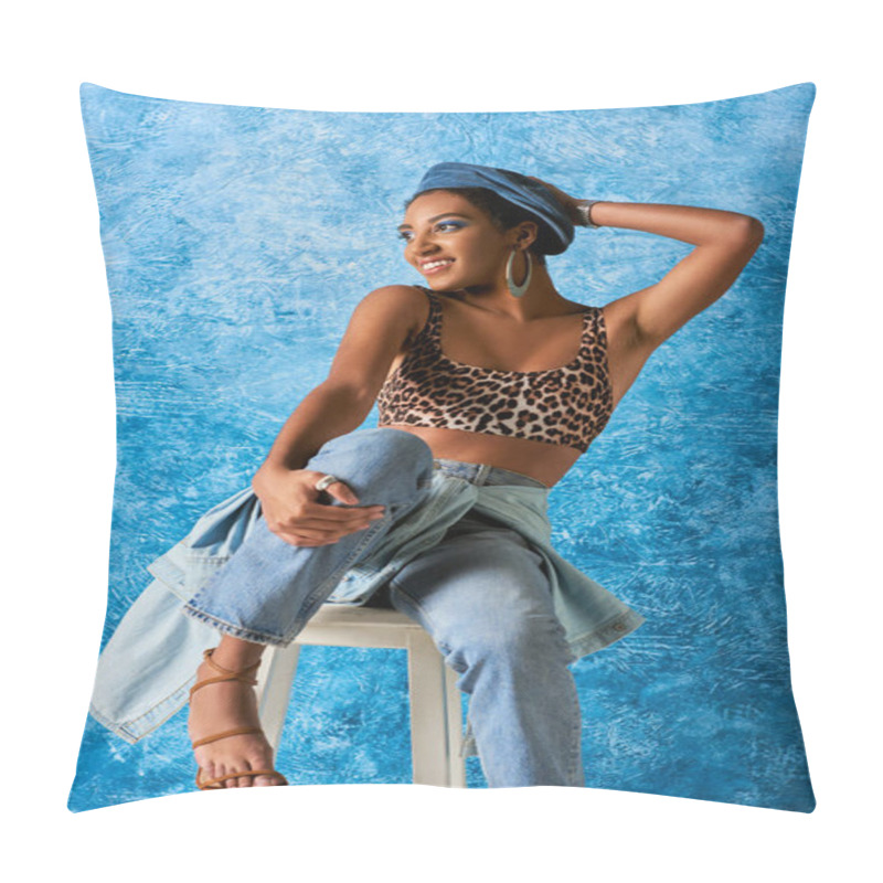 Personality  Trendy And Positive African American Woman In Beret And Golden Earring Wearing Top With Leopard Print And Jeans While Sitting On Chair On Blue Textured Background, Stylish Denim Attire Pillow Covers