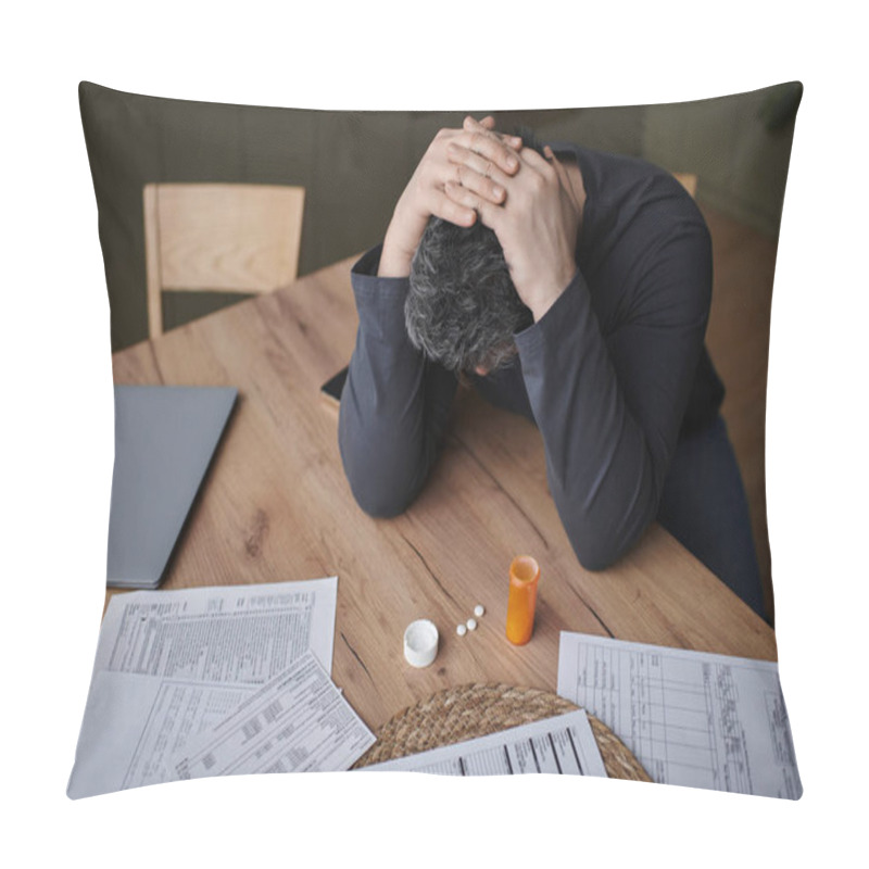 Personality  A Handsome Man At A Wooden Table Looks Stressed, Grasping His Head While Reviewing Papers. Pillow Covers