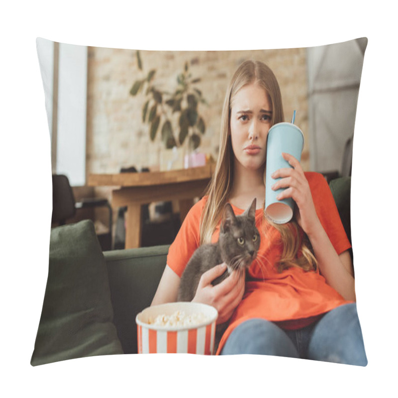 Personality  Selective Focus Of Sad Woman Holding Disposable Cup With Soda Near Popcorn Bucket And Cat While Watching Movie In Living Room  Pillow Covers