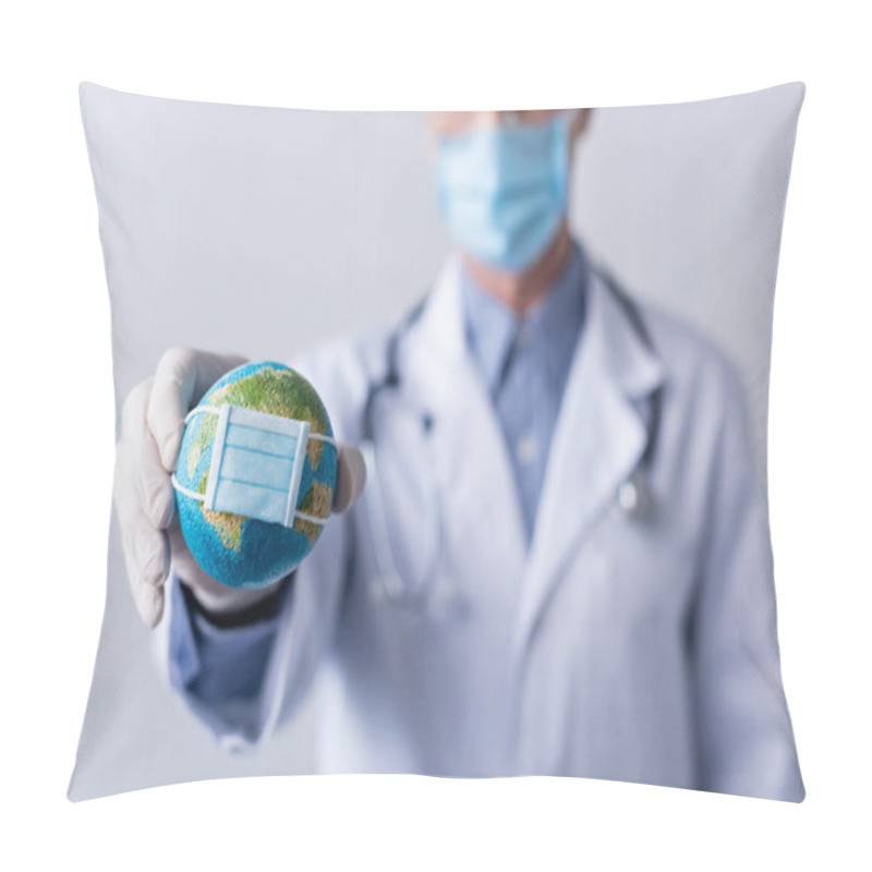 Personality  Selective Focus Of Mature Doctor In Latex Glove Holding Small Globe In Medical Mask On Grey Pillow Covers