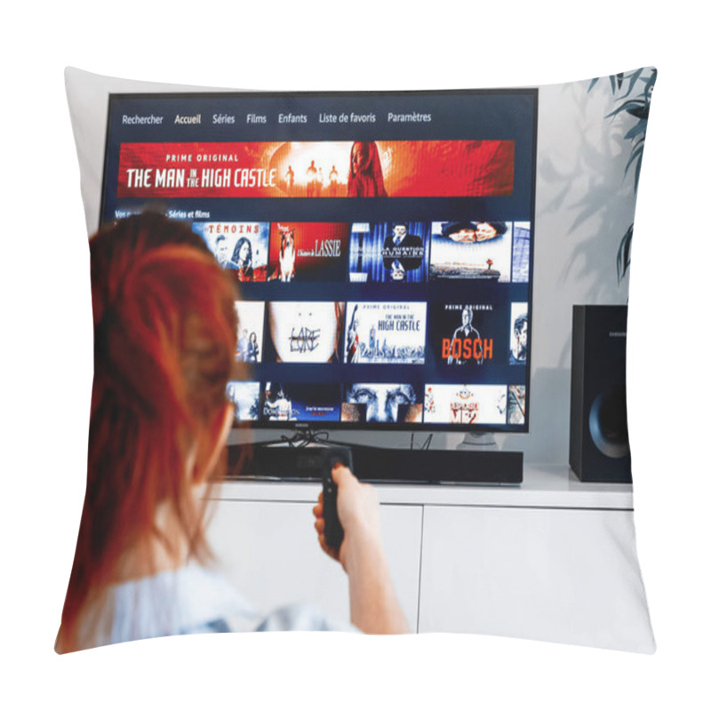 Personality  Benon, France - December 30, 2018: Woman Holding A Tv Remote Control Facing A Screen Displaying In French Language The Homepage Of Prime Video, A Video-on-demand Service Created By Amazon.com Pillow Covers