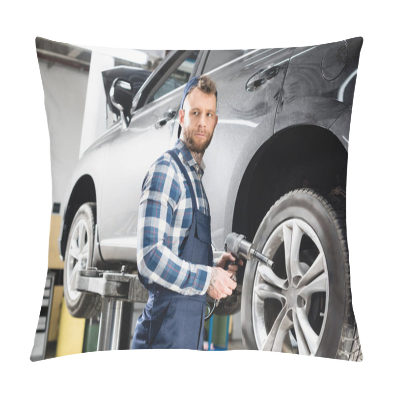 Personality  Young Technician Looking Away While Holding Pneumatic Wrench Near Wheel Of Lifted Car Pillow Covers