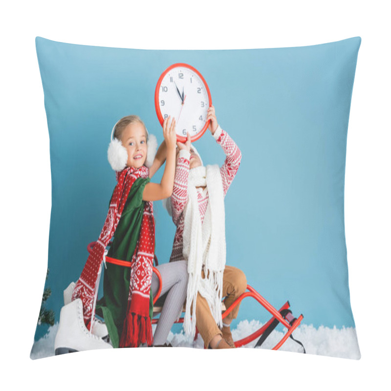 Personality  Kids In Winter Outfit Sitting On Sleigh And Holding Clock Near Pine And Ice Skates On Blue Pillow Covers