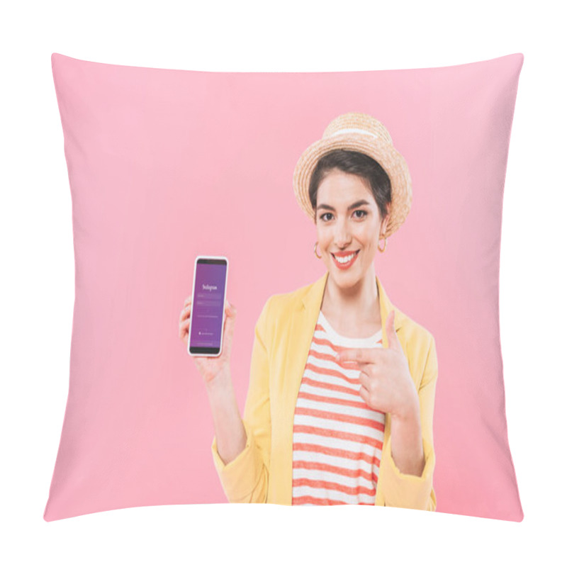 Personality  KYIV, UKRAINE - APRIL 24, 2019: Smiling Mixed Race Woman Showing Smartphone With Instagram App On Screen Isolated On Pink. Pillow Covers