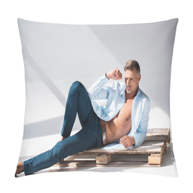 Personality  Sexy Man With Unbuttoned Shirt Lying On Wooden Pallet On White And Looking Away Pillow Covers