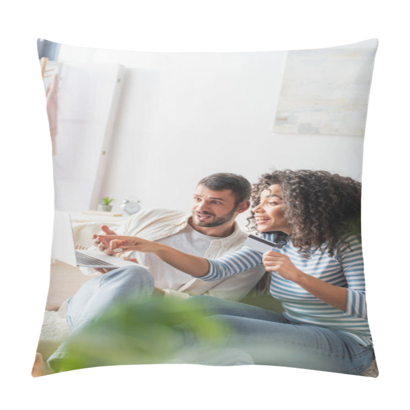 Personality  Excited Interracial Couple Shopping Online While Using Laptop In Bedroom With Blurred Foreground  Pillow Covers