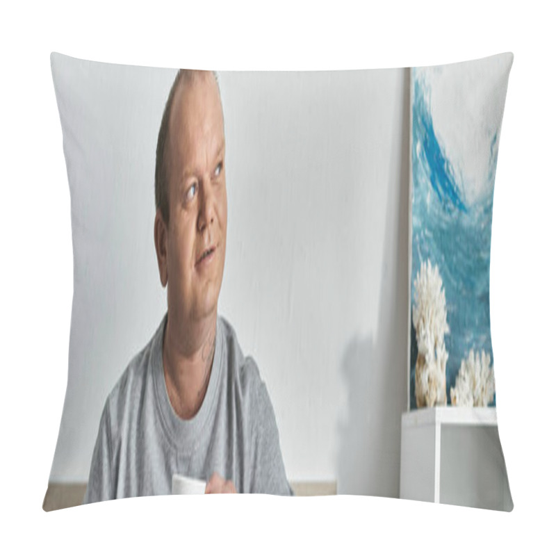 Personality  A Man With Inclusivity Sits In A Room, Holding A Cup, And Looks Up, Lost In Thought, With A Painting Of Crashing Waves In The Background. Pillow Covers