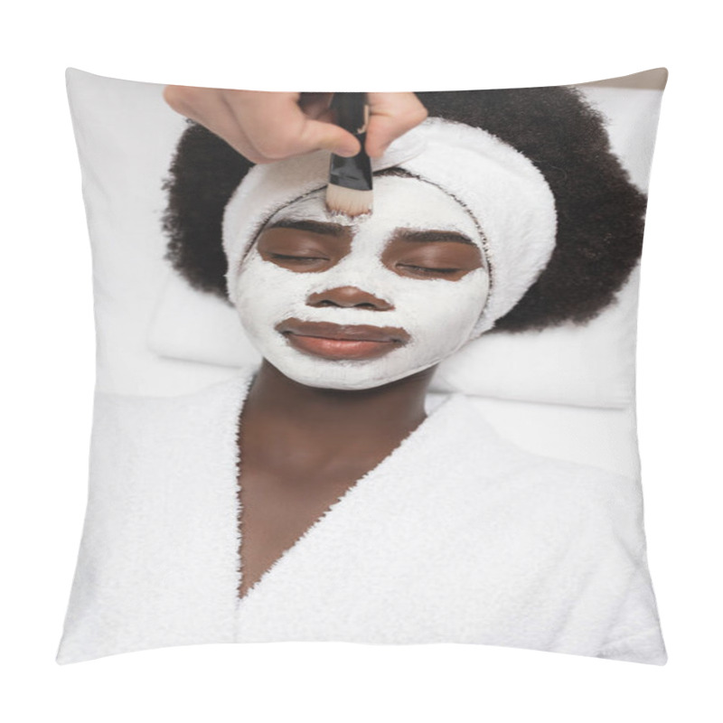 Personality  Top View Of Positive African American Woman Wearing Bathrobe, Lying Near Spa Therapist Applying Face Mask On Forehead In Spa Salon Pillow Covers