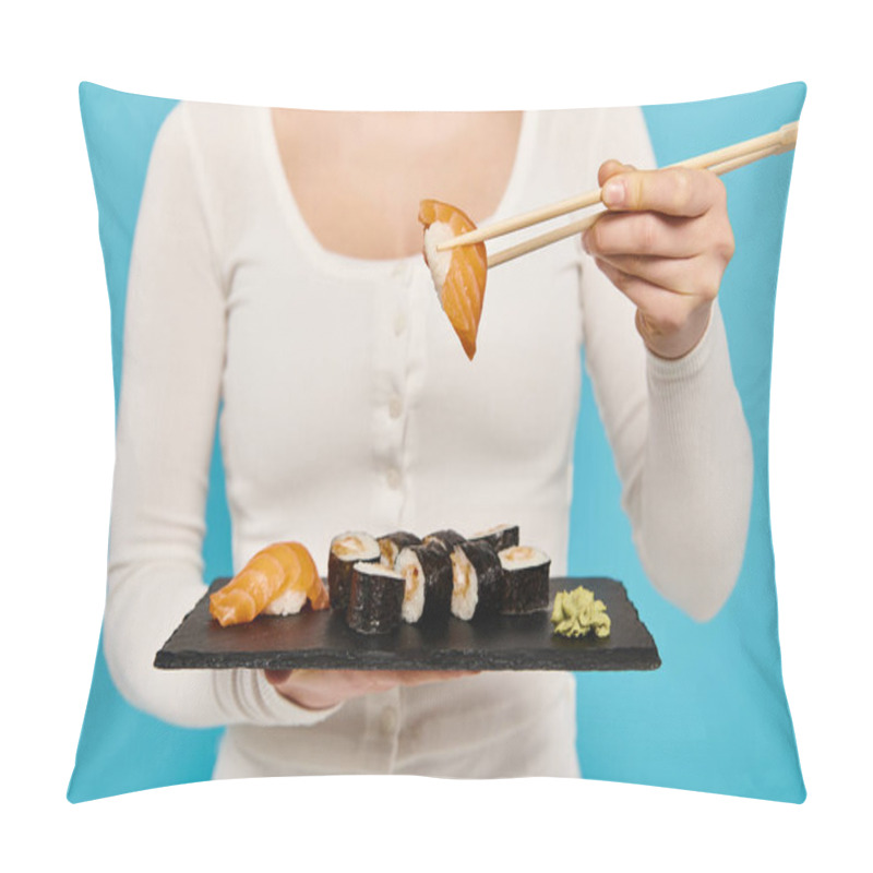 Personality  Cropped View Of Woman Elegantly Holds A Plate Of Sushi And Chopsticks, Savoring Each Bite With A Serene Expression. Pillow Covers