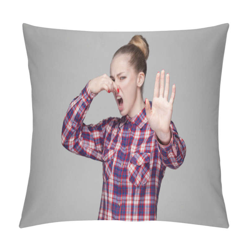 Personality  Angry Blonde Woman In Pink Checkered Shirt With Collected Bun Hairstyle Looking At Camera With Stop Gesture And Pinching Her Nose On Gray Background Pillow Covers