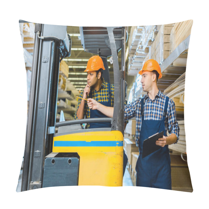 Personality  Indian Warehouse Worker Sitting In Forklift Machine Near Colleague Pointing With Pencil Pillow Covers