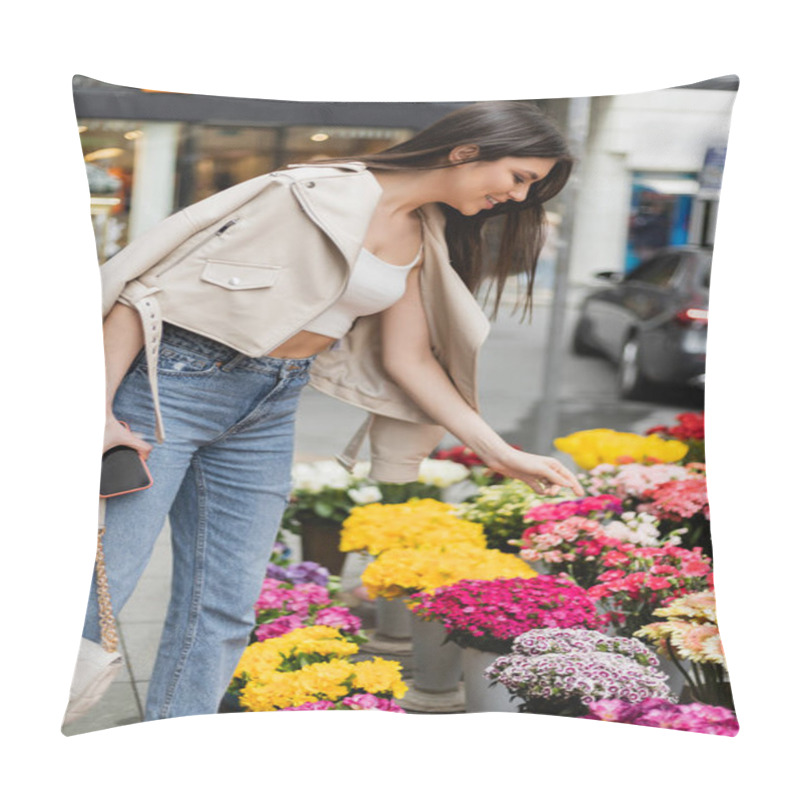 Personality  Cheerful Young Woman With Long Hair Standing In Beige Leather Jacket While Holding Handbag With Chain Strap And Smartphone Near Flowers On Street In Istanbul, Vendor  Pillow Covers