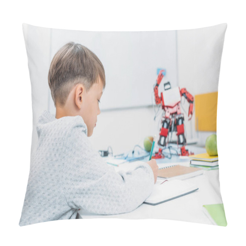 Personality  Schoolboy Sitting At Desk With Robot Model And Writing In Notebook During STEM Lesson Pillow Covers