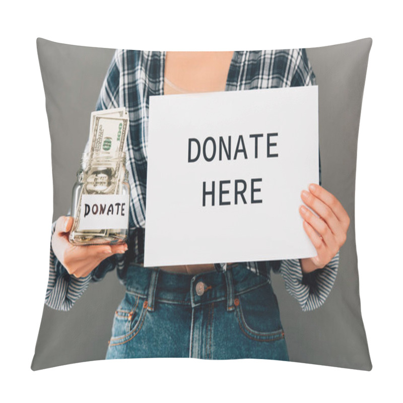 Personality  Cropped View Of Woman Holding Card With Donate Here Lettering And Jar With Money On Grey Background Pillow Covers