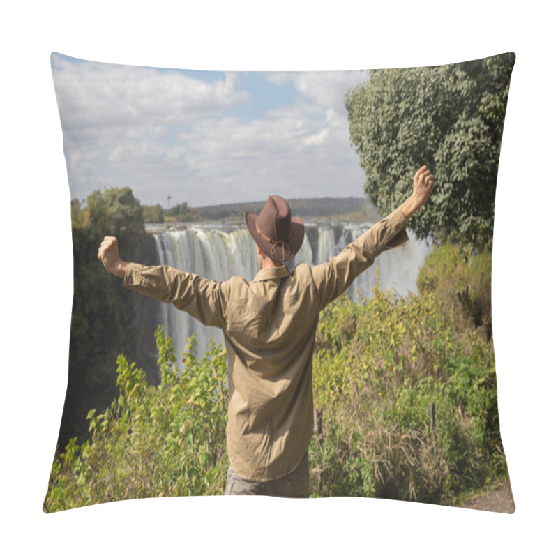 Personality  A Man In A Cowboy Hat Stands On A Cliff Against The Background Of Victoria Falls With His Arms Outstretched. Rear View Pillow Covers