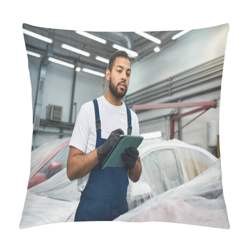 Personality  Handsome Mechanic In Overalls Examines Cars And Writes Important Details In A Busy Garage. Pillow Covers